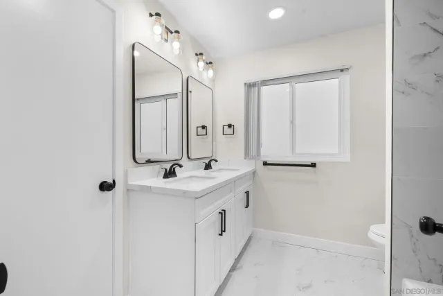 a bathroom with a double vanity sink and mirror