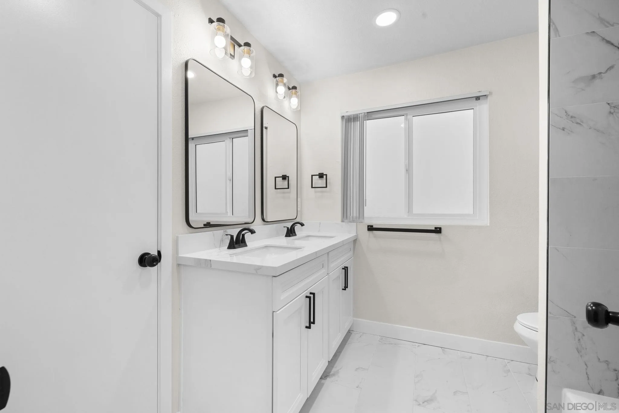 748 North 3rd Street, Unit Q El Cajon, CA 92021 - Photo 10 of 16 a bathroom with a double vanity sink and mirror