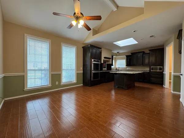 a view of kitchen with cabinets and wooden floor
