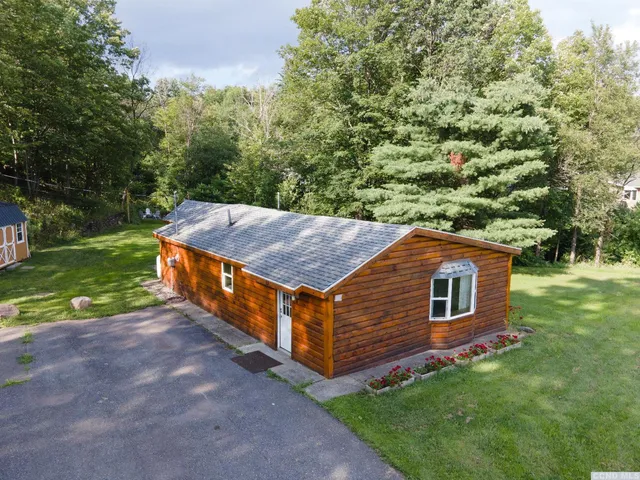 a backyard of a house with a garden and outdoor seating