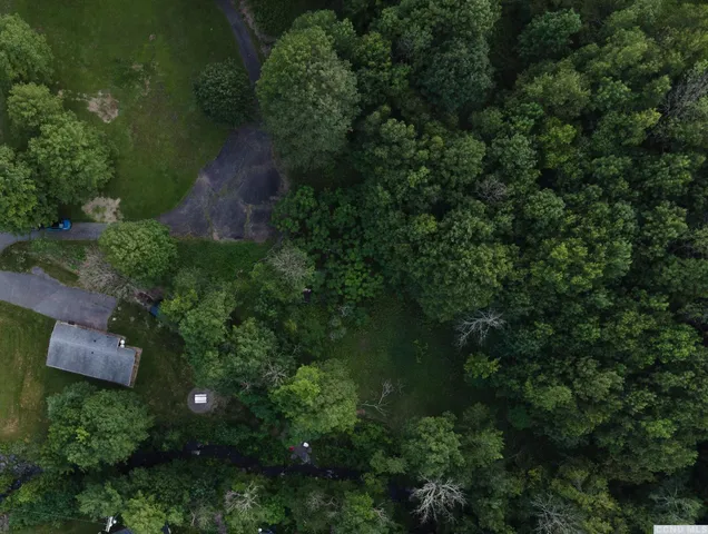 an aerial view of a house with pool yard and outdoor seating