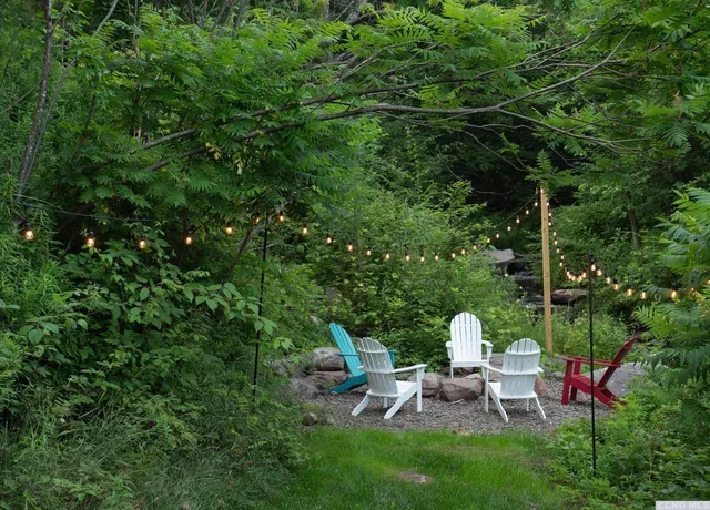 a view of a chairs in backyard of the house