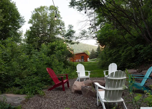 a view of a chairs and table in the garden