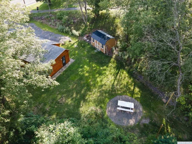 an aerial view of a house with a yard