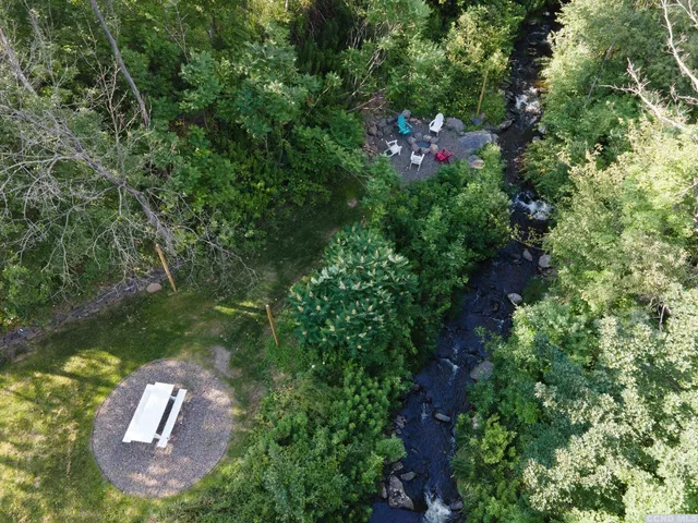 an aerial view of a house with a yard basket ball court and outdoor seating