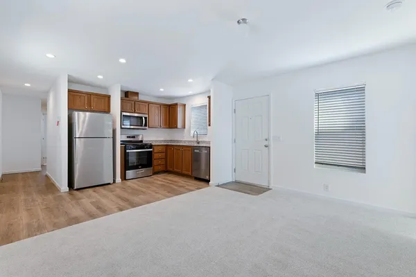 a kitchen with stainless steel appliances granite countertop a refrigerator stove and oven