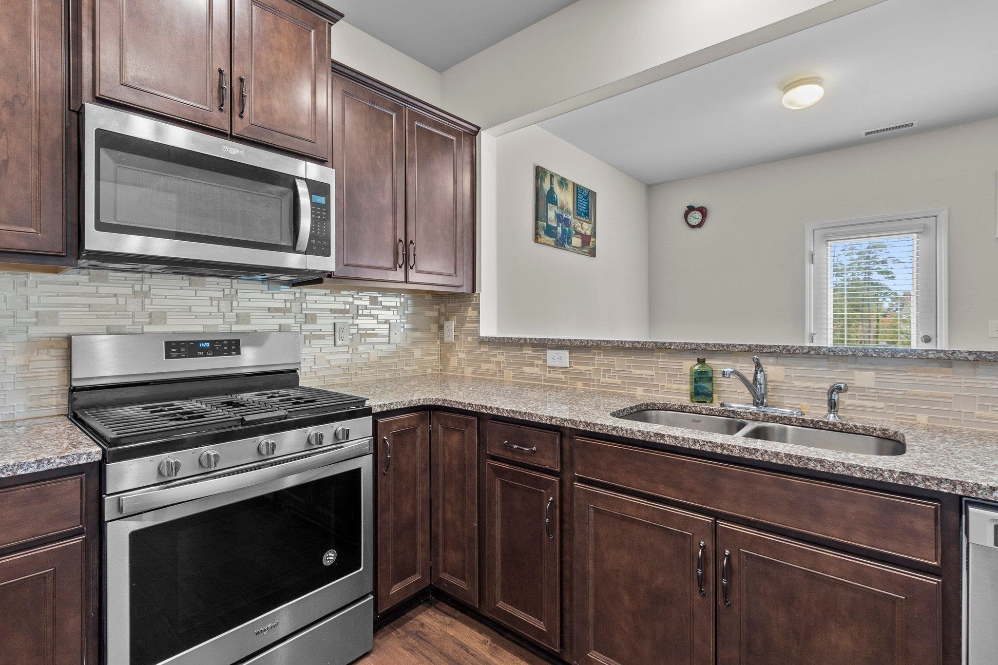 1022 Saffron Loop Durham, NC 27713 - Photo 11 of 22 a kitchen with stainless steel appliances granite countertop a stove microwave and sink