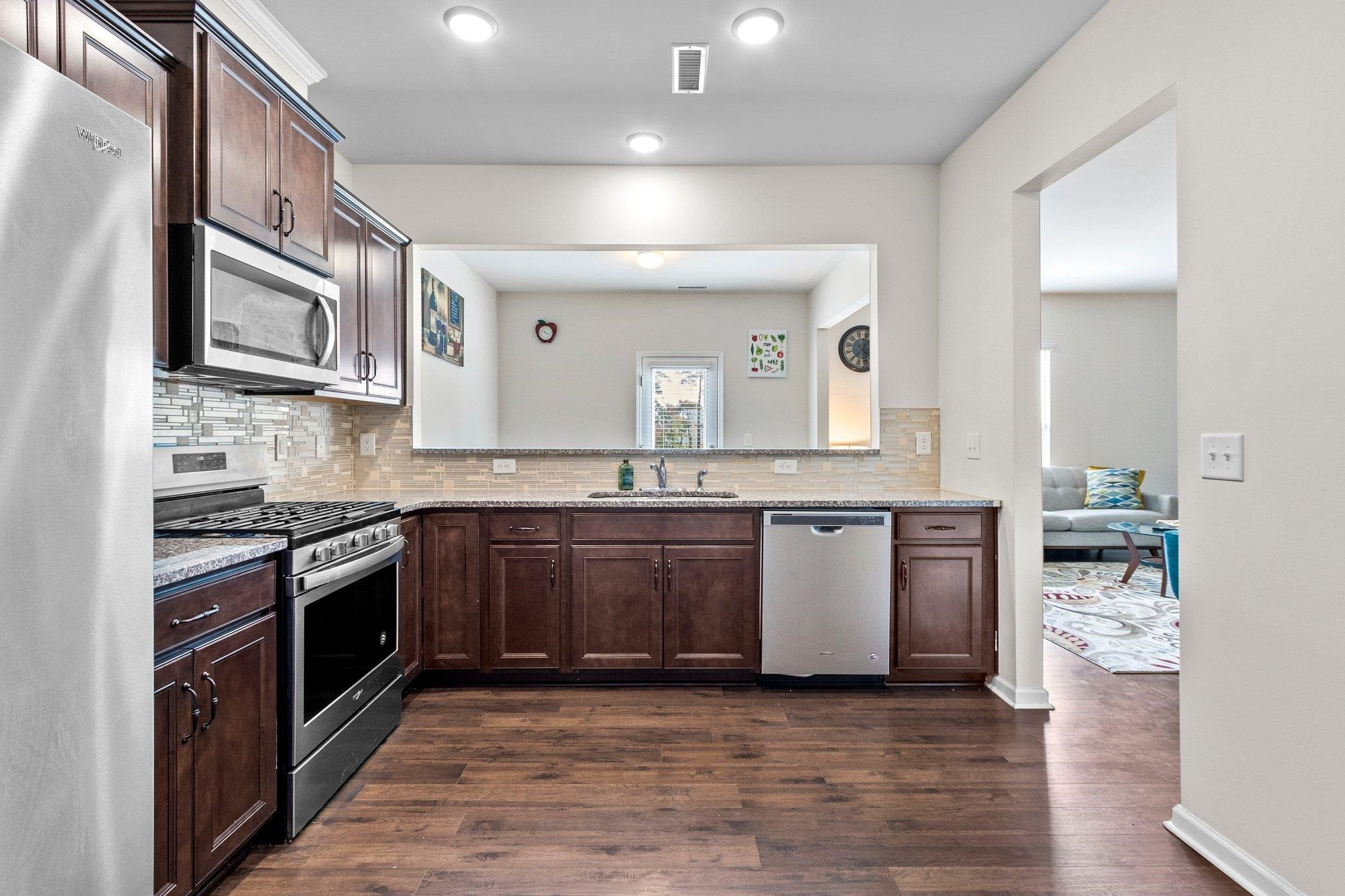1022 Saffron Loop Durham, NC 27713 - Photo 12 of 22 a large kitchen with stainless steel appliances granite countertop a stove and a sink