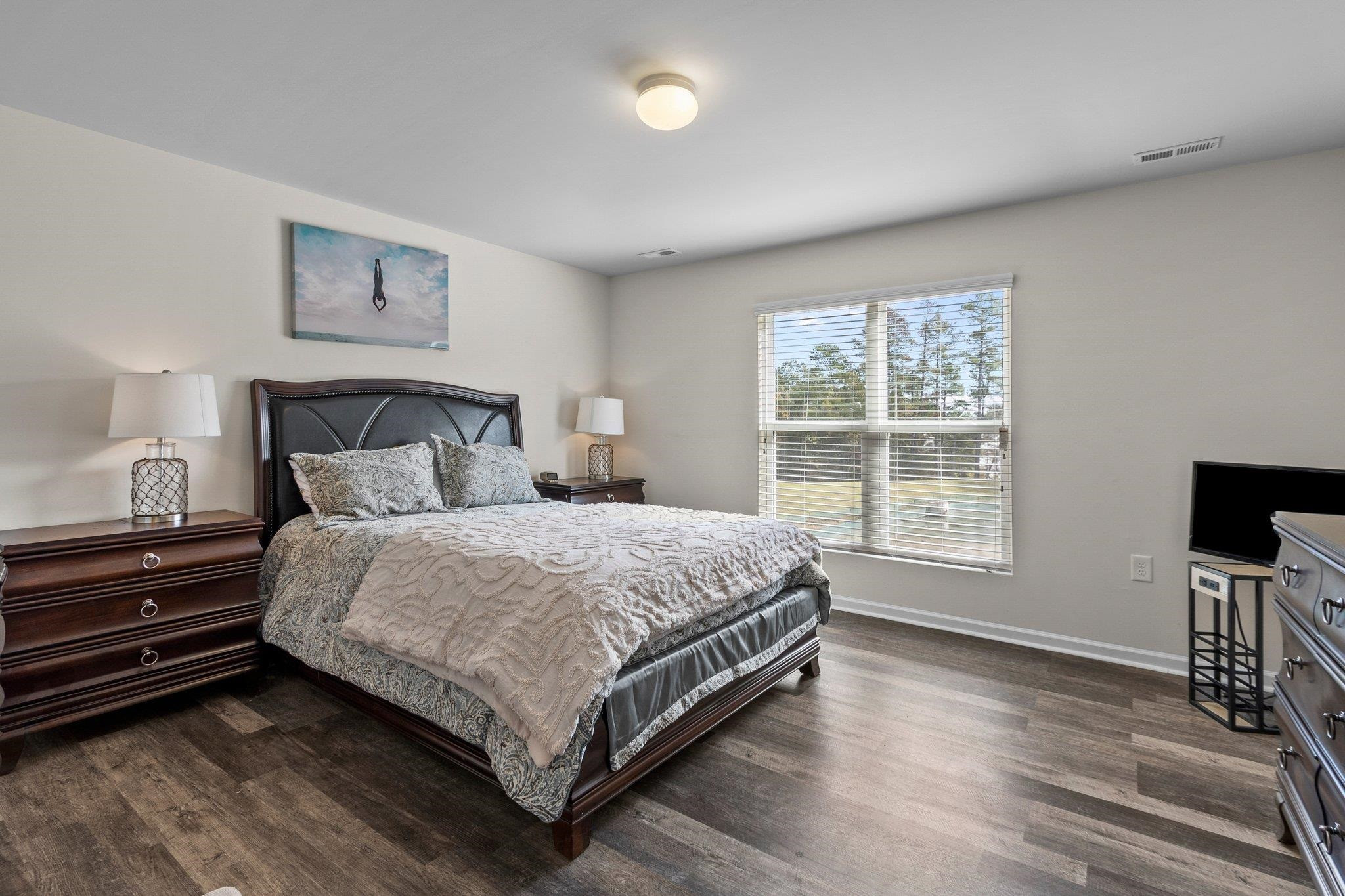 1022 Saffron Loop Durham, NC 27713 - Photo 13 of 22 a bedroom with a bed and a window