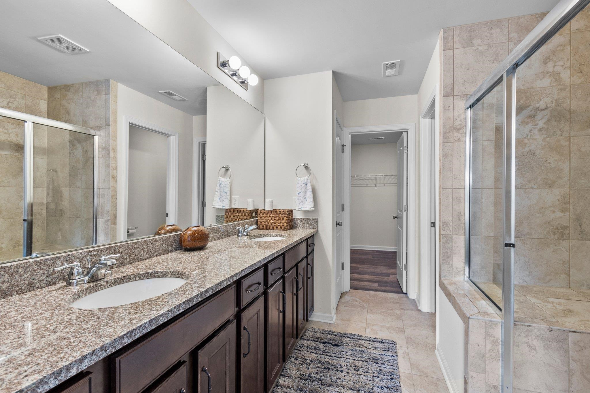 1022 Saffron Loop Durham, NC 27713 - Photo 14 of 22 a bathroom with a granite countertop sink and a mirror