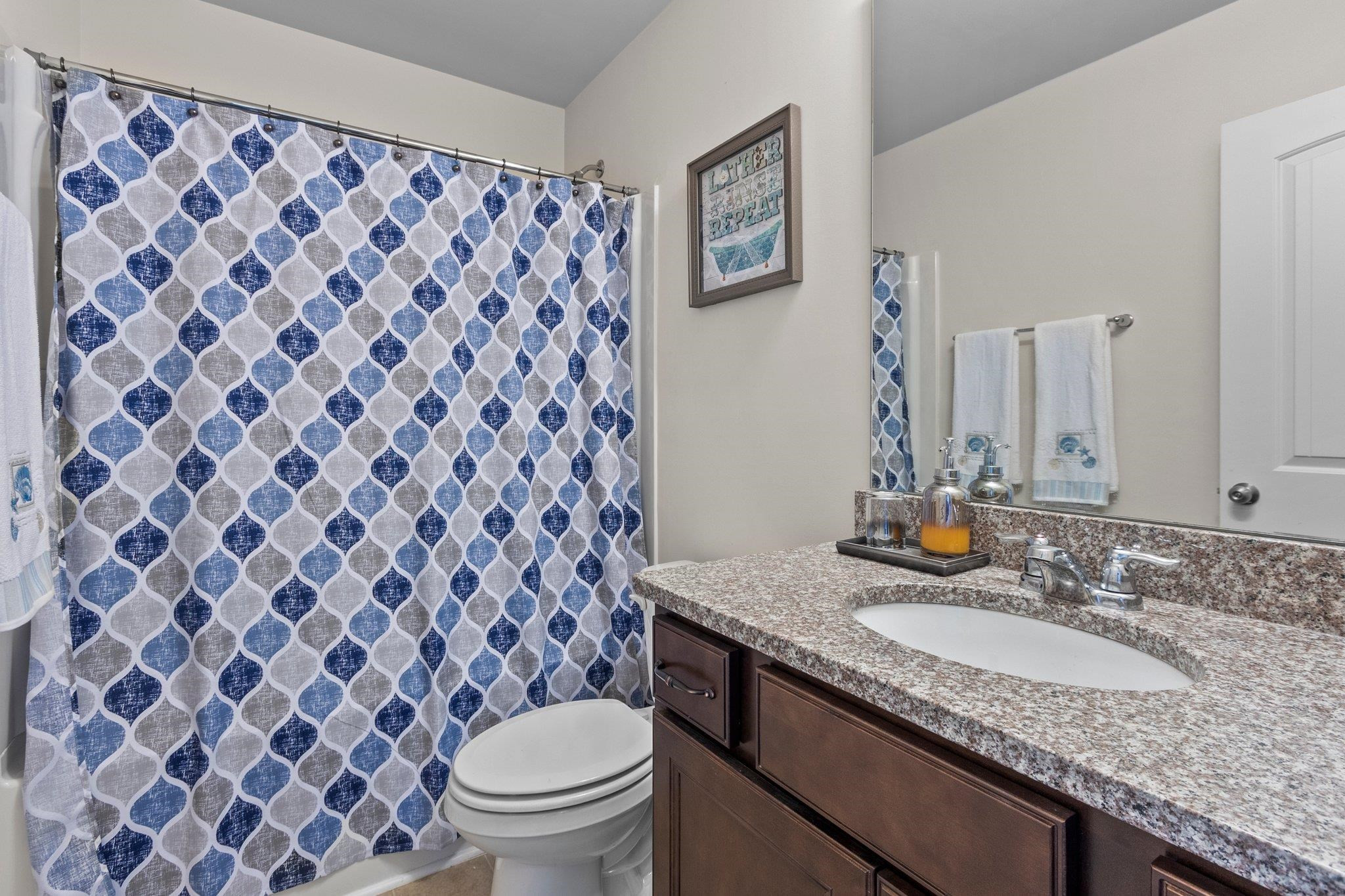 1022 Saffron Loop Durham, NC 27713 - Photo 18 of 22 a bathroom with a granite countertop sink and a mirror