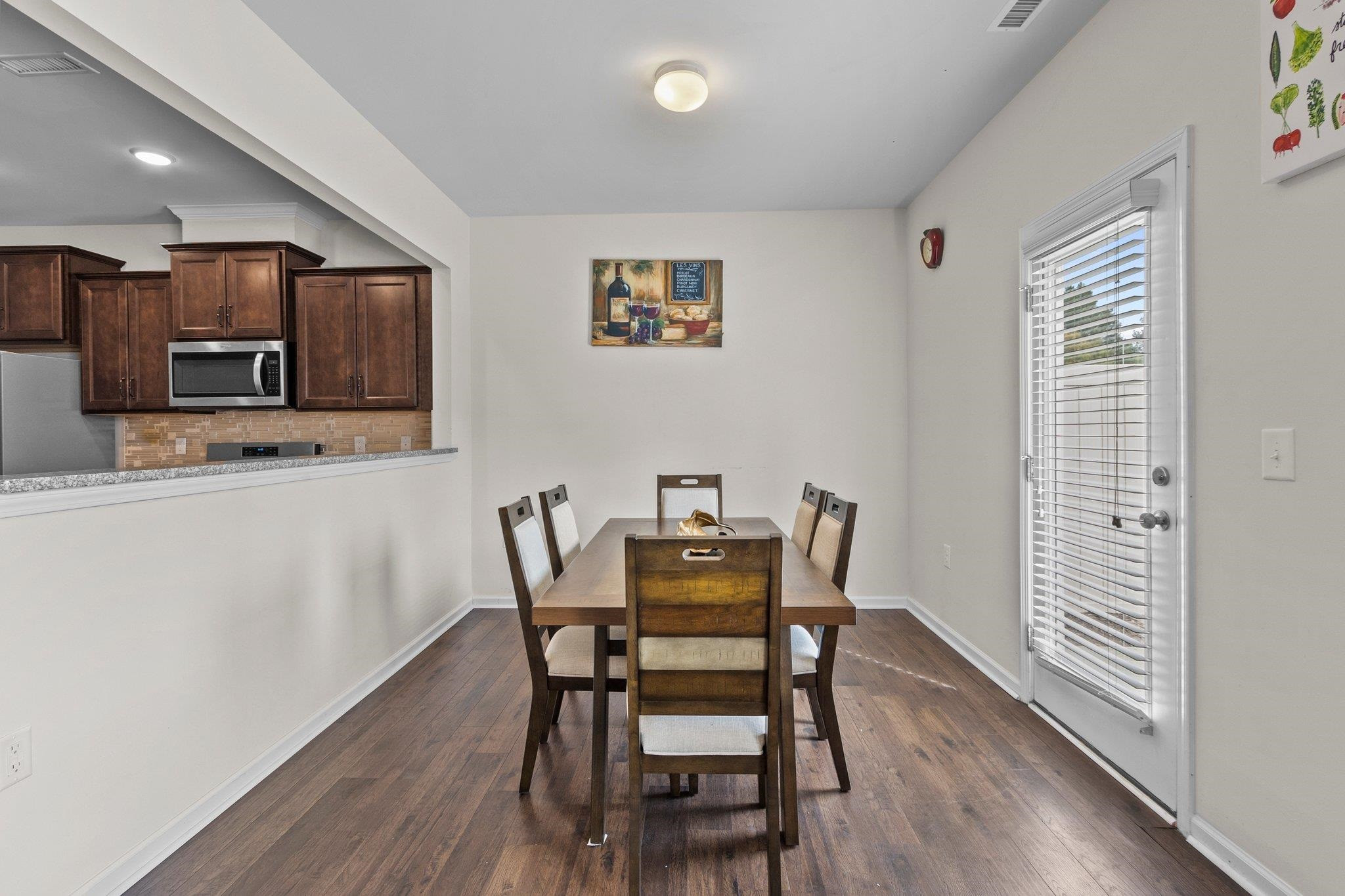 1022 Saffron Loop Durham, NC 27713 - Photo 7 of 22 a view of a dining room with furniture and wooden floor