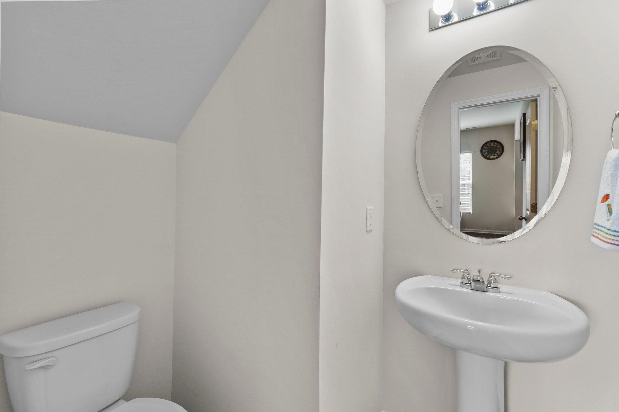 1022 Saffron Loop Durham, NC 27713 - Photo 9 of 22 a bathroom with a toilet sink and mirror