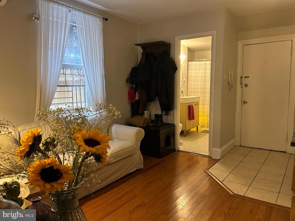 1227 Spruce Street, Unit 1R Philadelphia, PA 19107 - Photo 1 of 6 a living room with furniture and a window