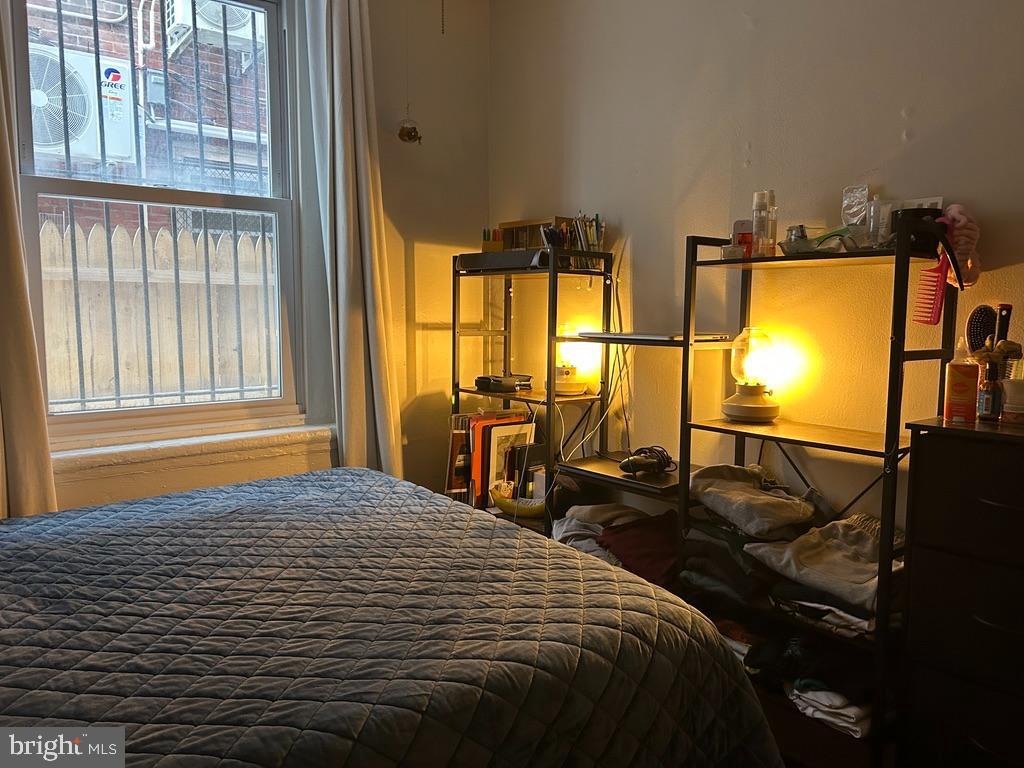1227 Spruce Street, Unit 1R Philadelphia, PA 19107 - Photo 4 of 6 a bedroom with a bed and glass windows