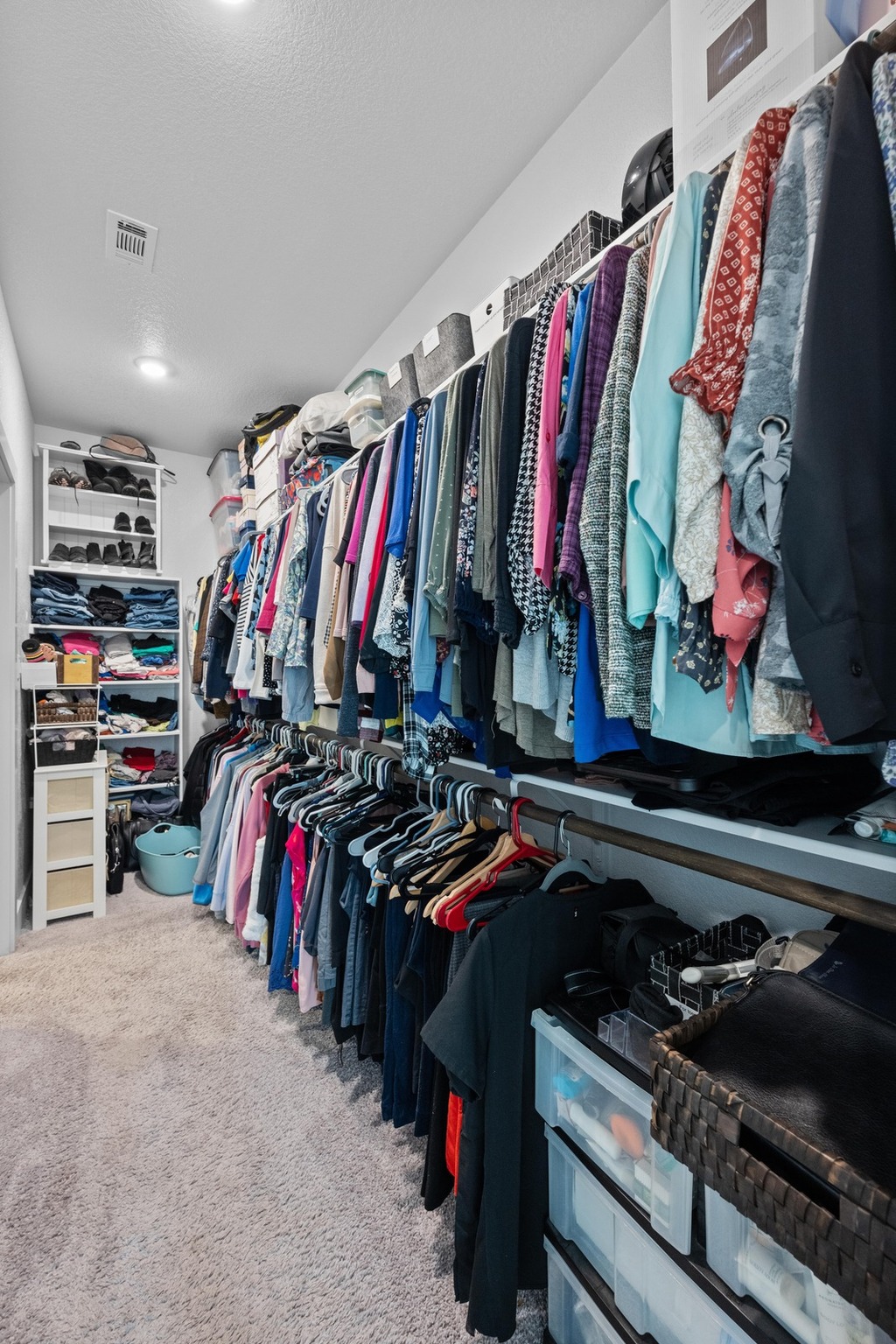 217 Palio Place Georgetown, TX 78628 - Photo 16 of 40 a view of walk in closet with clothes and shoes