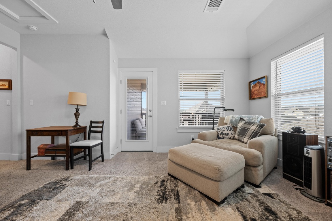 217 Palio Place Georgetown, TX 78628 - Photo 20 of 40 a bedroom with a bed a table and chair