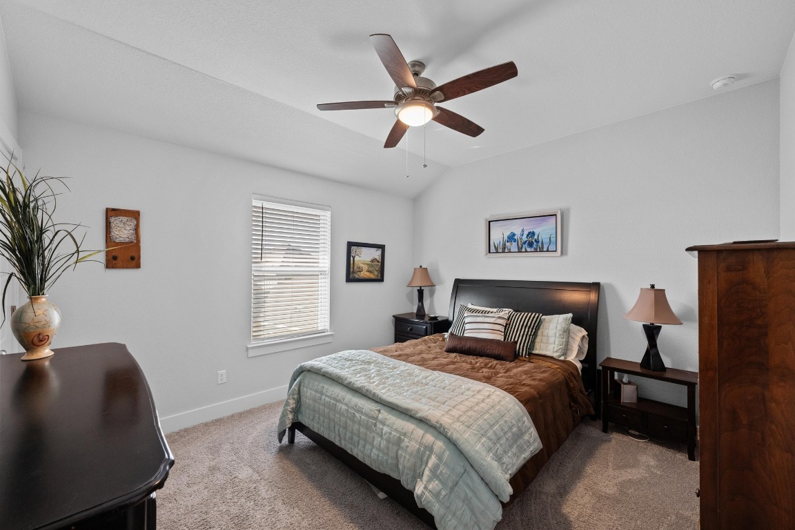 217 Palio Place Georgetown, TX 78628 - Photo 27 of 40 a bedroom with a bed a window and painting on the wall