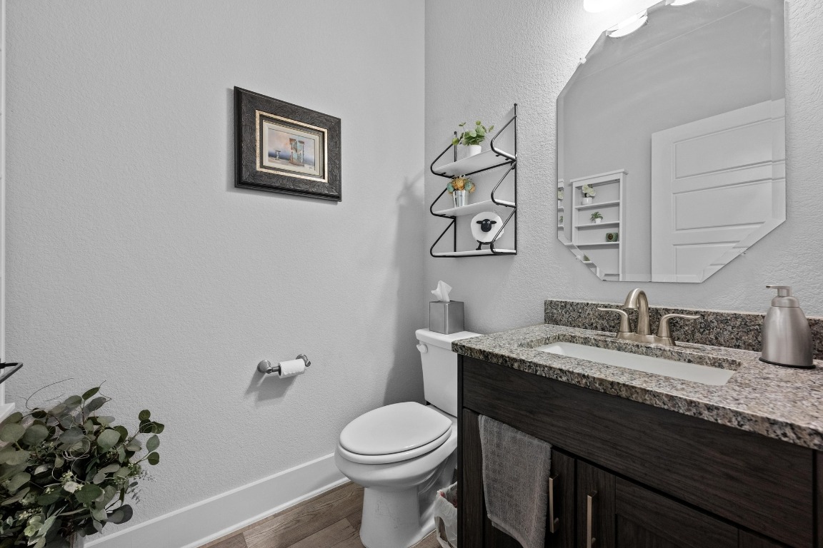 217 Palio Place Georgetown, TX 78628 - Photo 28 of 40 a bathroom with a granite countertop toilet sink and mirror