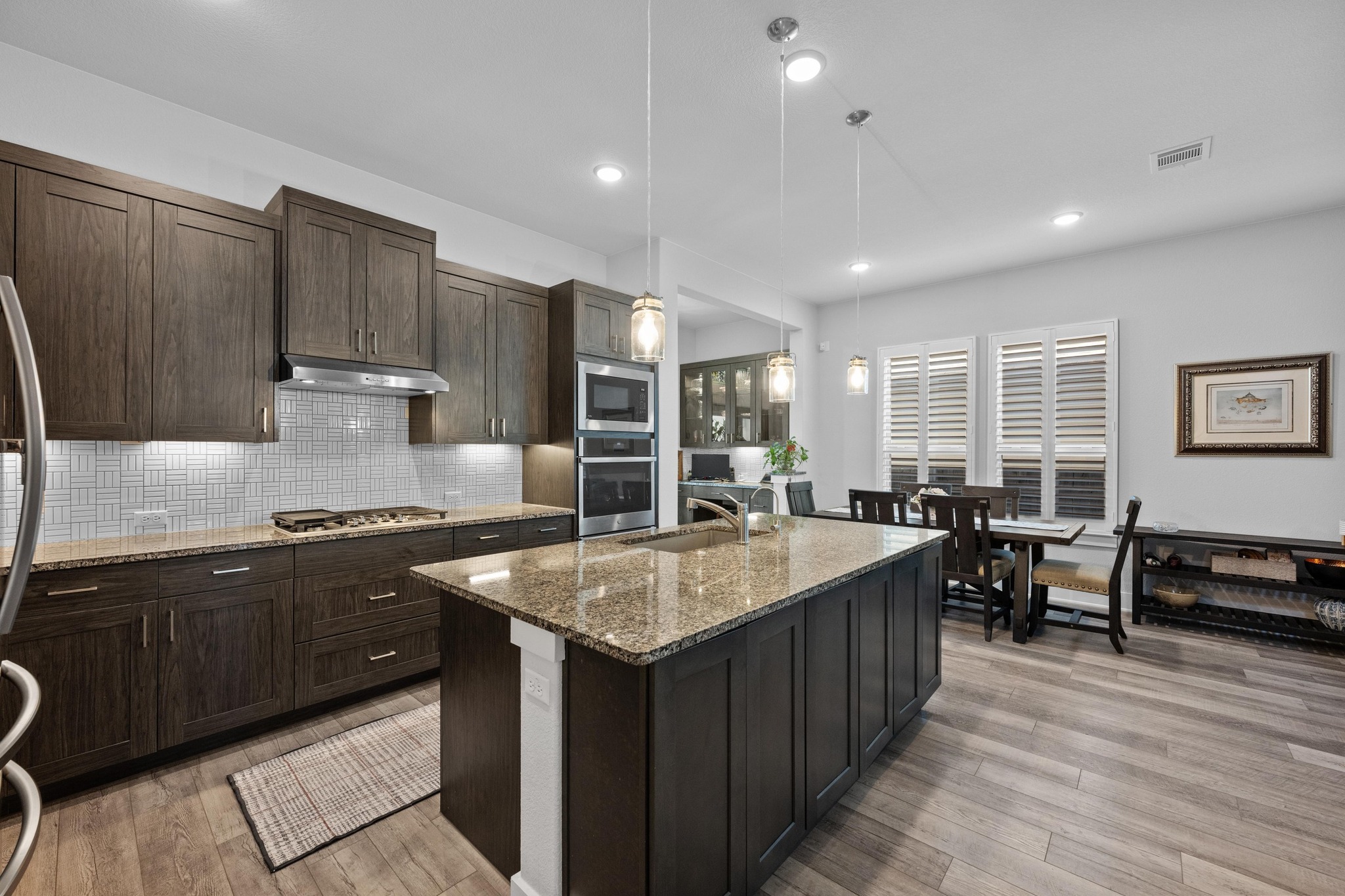 217 Palio Place Georgetown, TX 78628 - Photo 7 of 40 a large kitchen with kitchen island a sink counter space and stainless steel appliances