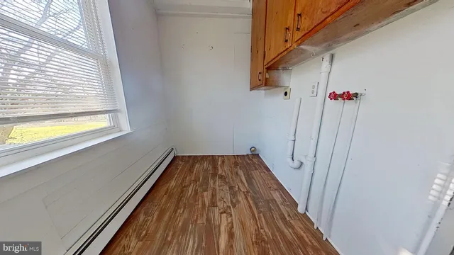 a view of a room with wooden floor and staircase