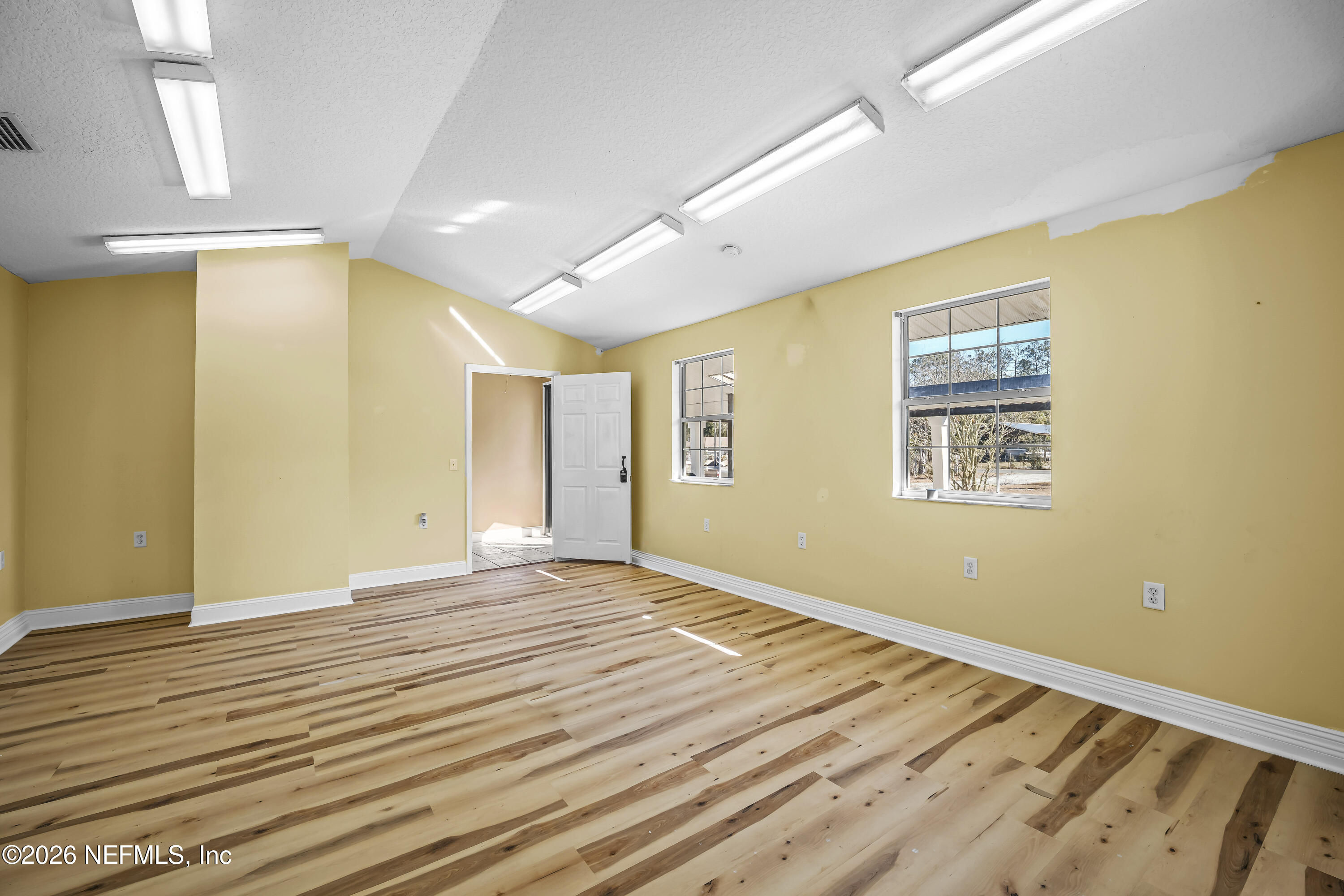35 Cinnamon Street Middleburg, FL 32068 - Photo 20 of 56 a view of an empty room with wooden floor and a window
