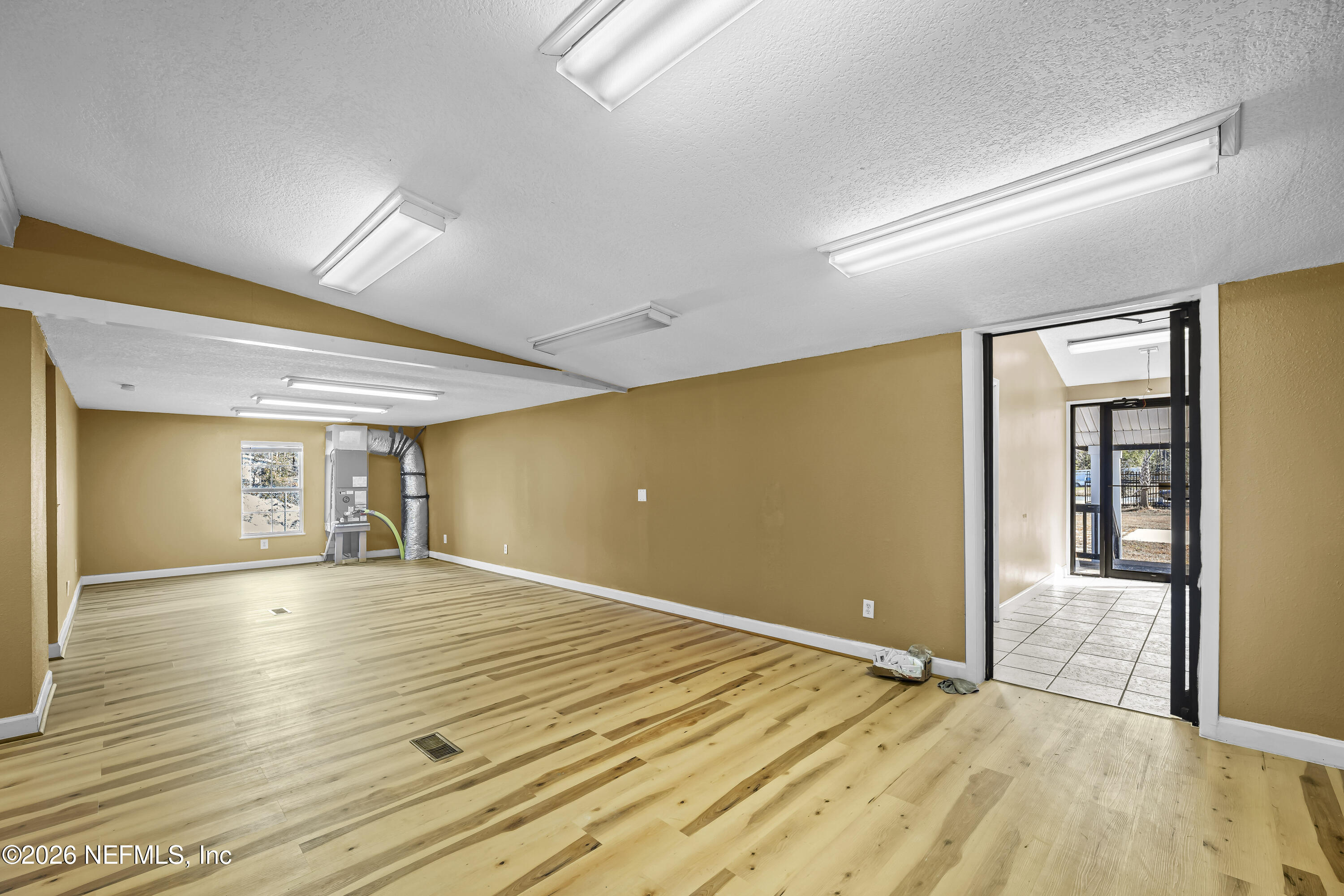 35 Cinnamon Street Middleburg, FL 32068 - Photo 25 of 56 a view of an empty room with wooden floor and a window
