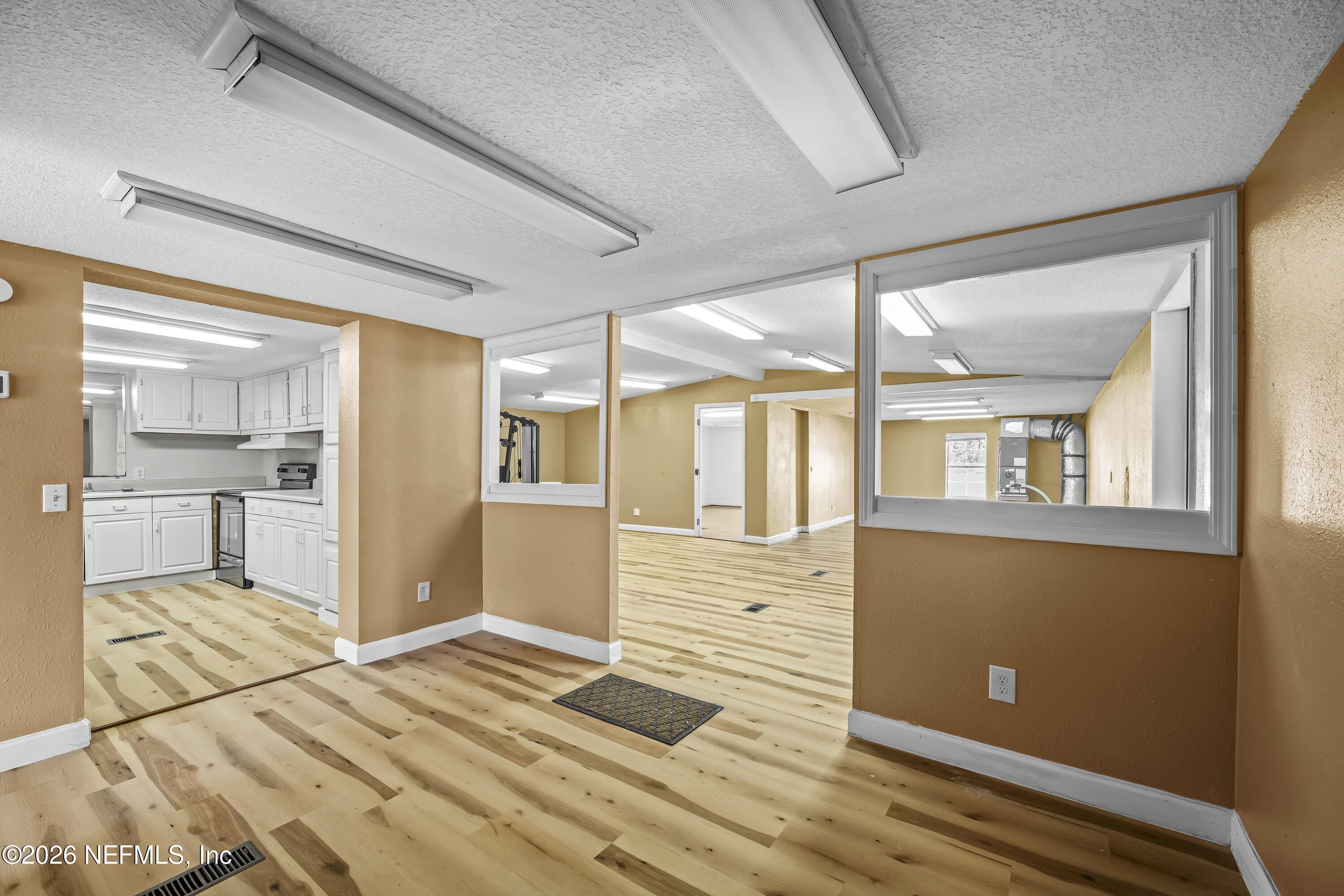 35 Cinnamon Street Middleburg, FL 32068 - Photo 31 of 56 a view of a hallway with wooden floor and a kitchen