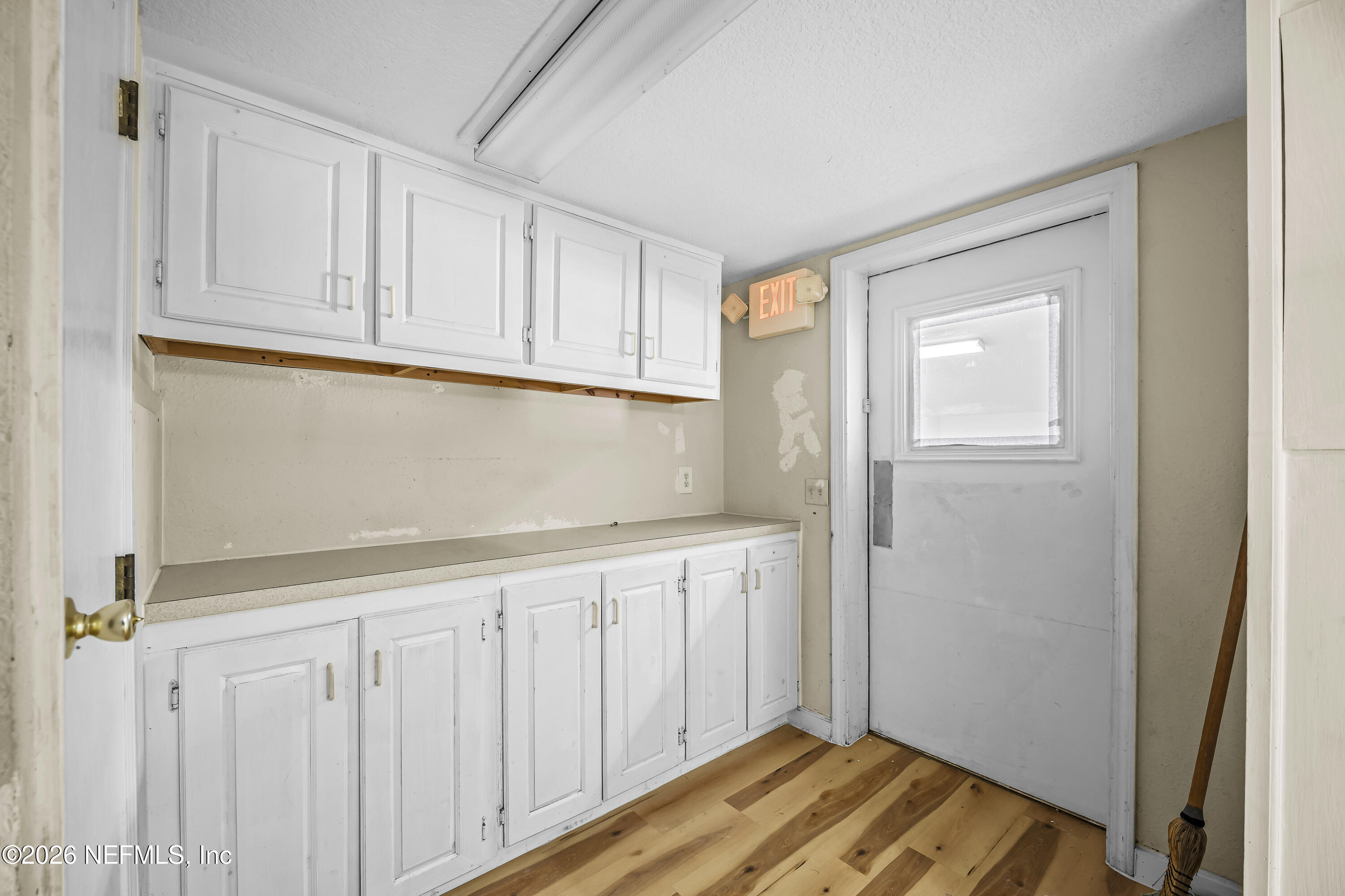 35 Cinnamon Street Middleburg, FL 32068 - Photo 33 of 56 a view of a kitchen with white cabinets and wooden floor
