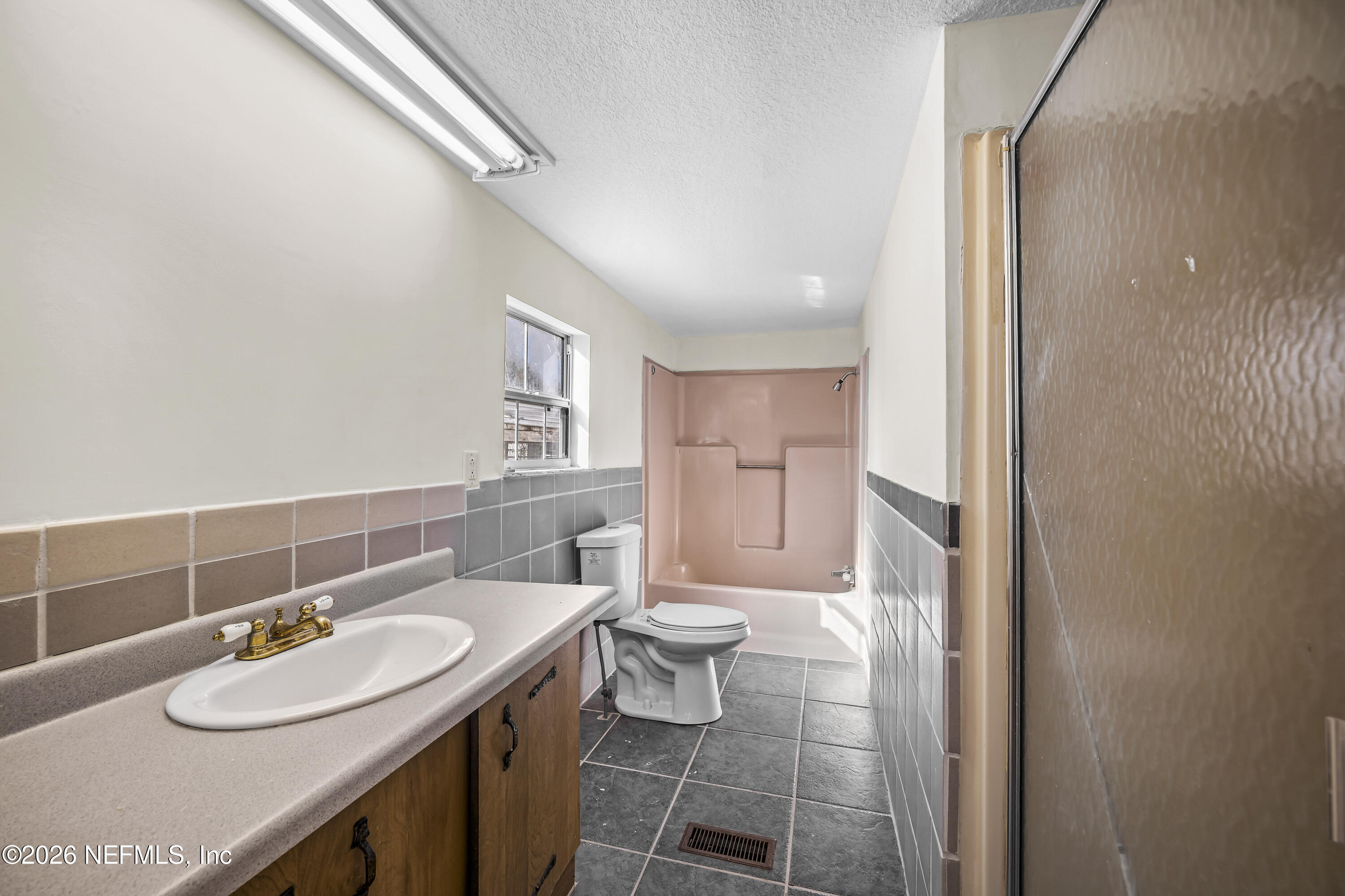 35 Cinnamon Street Middleburg, FL 32068 - Photo 36 of 56 a bathroom with a granite countertop sink a toilet and a mirror