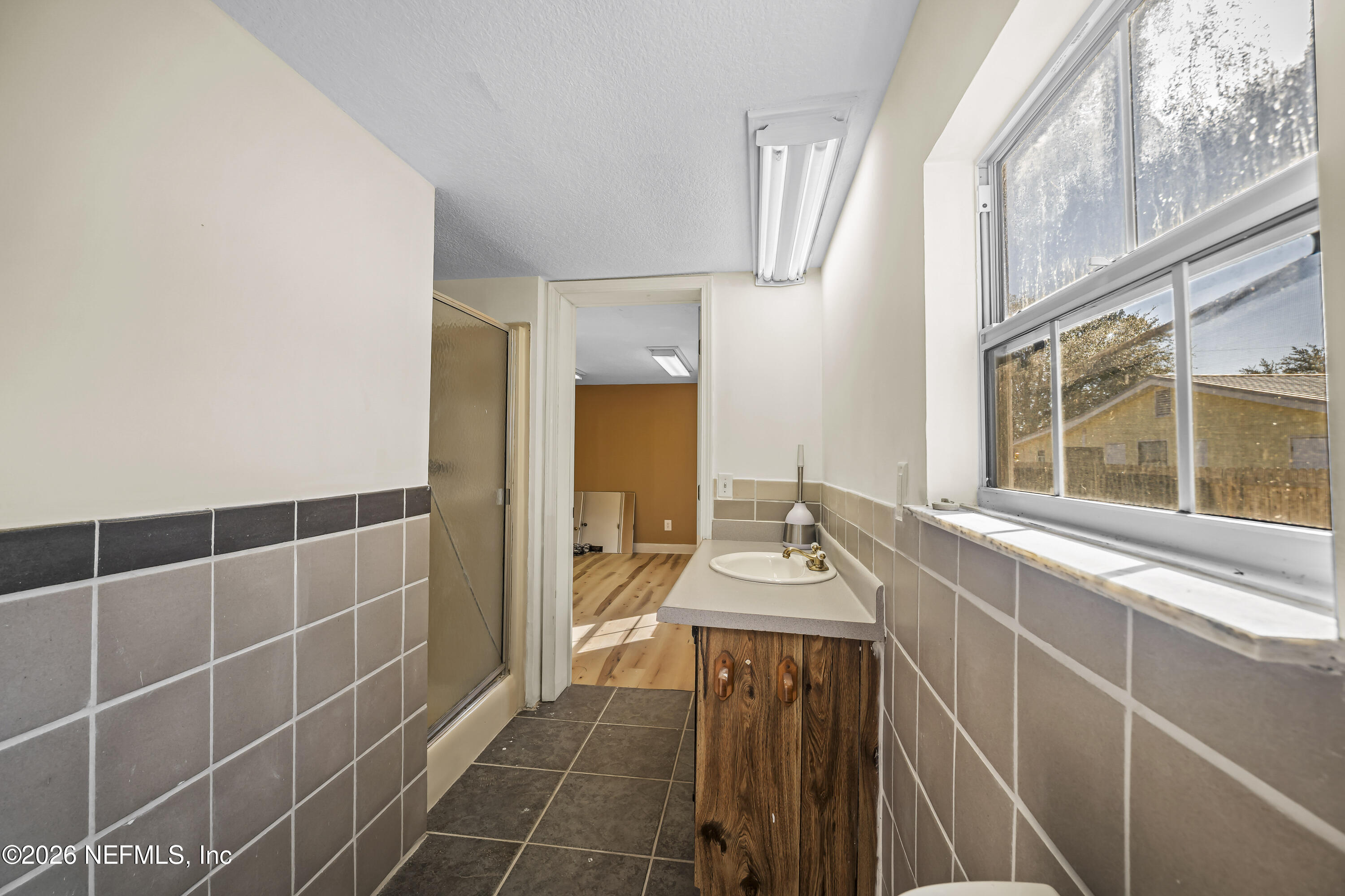 35 Cinnamon Street Middleburg, FL 32068 - Photo 37 of 56 a bathroom with a sink a mirror and a shower