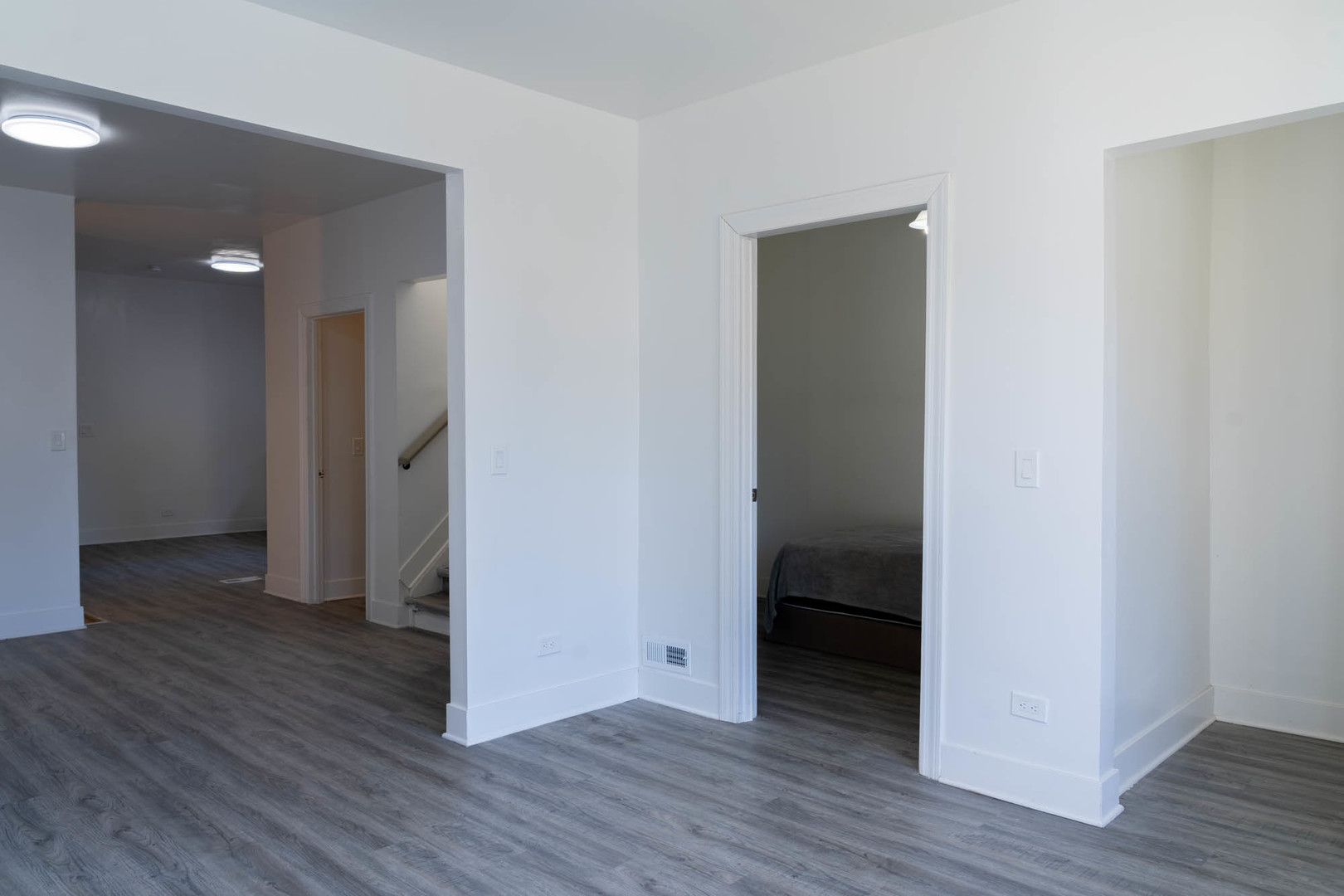 6843 South Carpenter Street Chicago, IL 60621 - Photo 2 of 11 an empty room with wooden floor and entrance