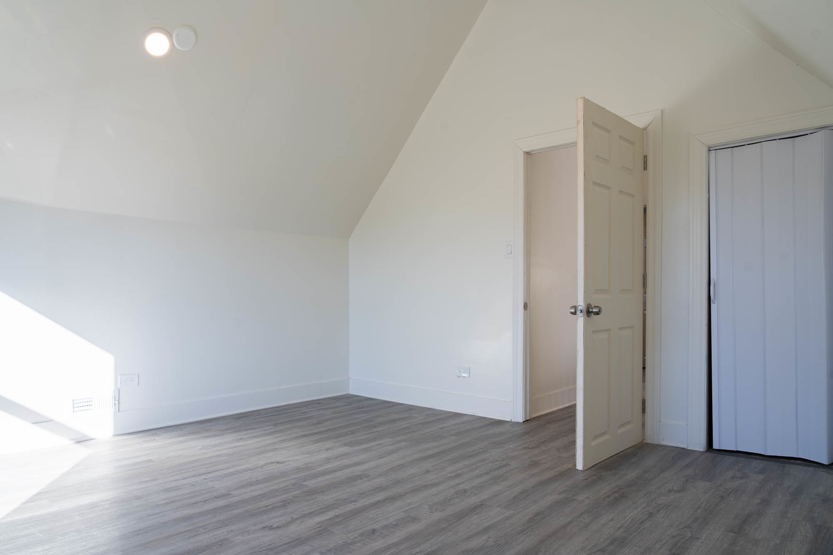 6843 South Carpenter Street Chicago, IL 60621 - Photo 3 of 11 a view of an empty room with wooden floor and closet