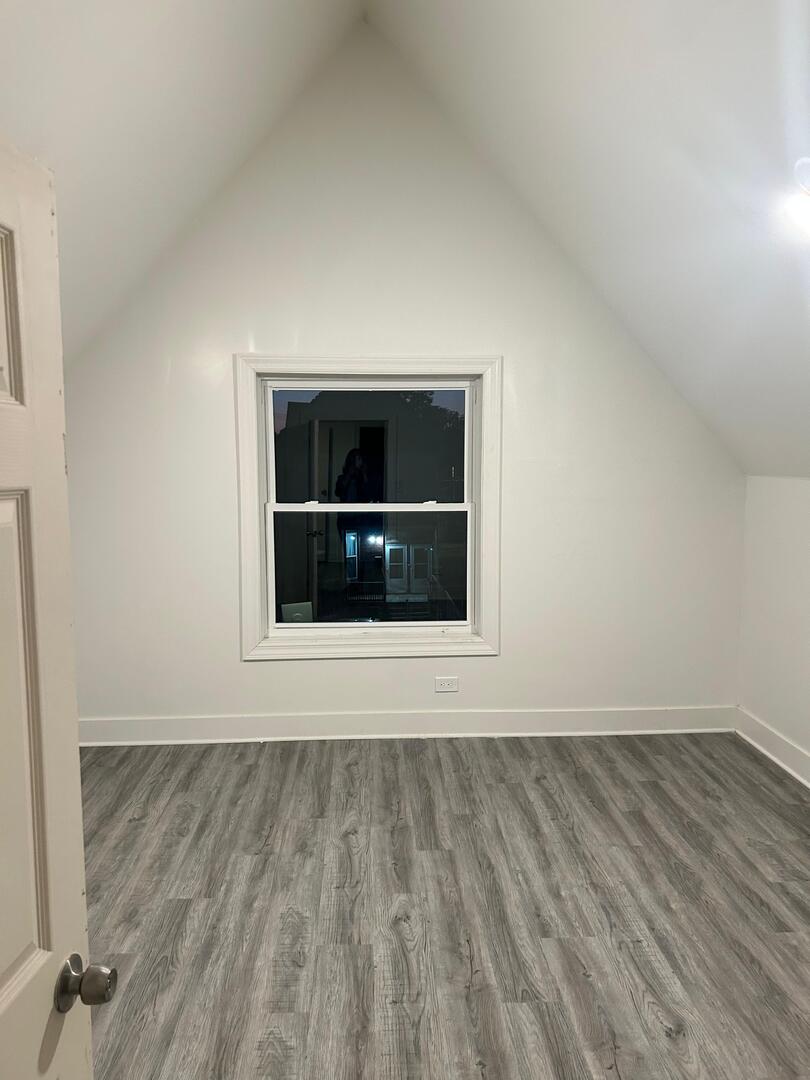 6843 South Carpenter Street Chicago, IL 60621 - Photo 8 of 11 a view of empty room with wooden floor