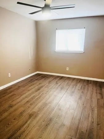 a view of a room with wooden floor