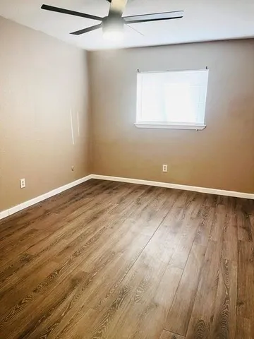 a view of a room with wooden floor