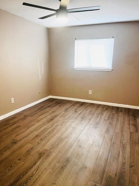 5017 Meandering Lane, Unit A Corpus Christi, TX 78413 - Photo 8 of 13 an empty room with wooden floor and windows