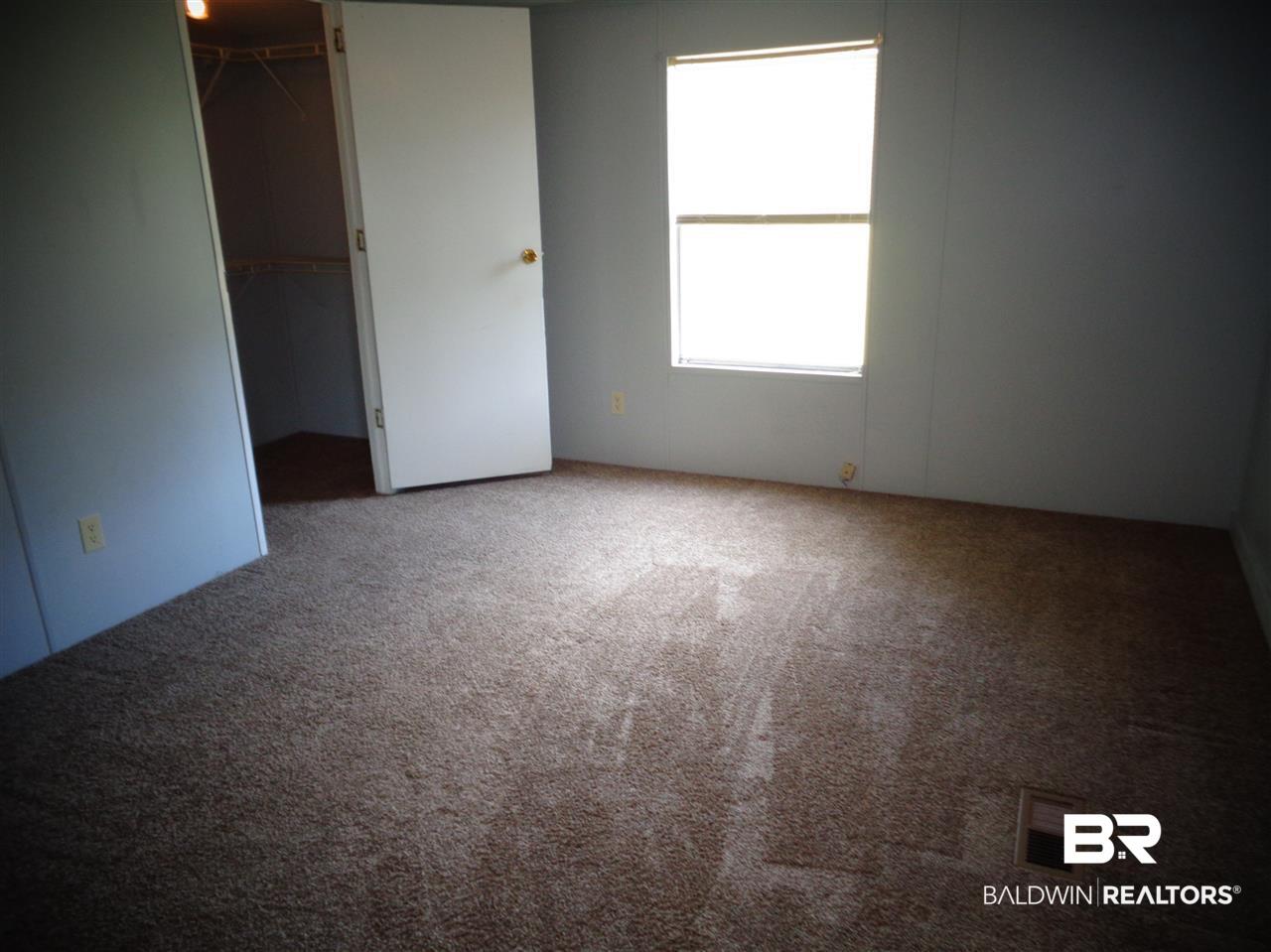 21535 A Glass And Spivey Road Robertsdale, AL 36567 - Photo 2 of 32 13x11. Ceiling fan/light. Carpet. Walk-in closet