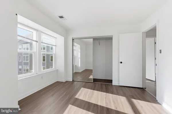 a view of wooden floor and windows in a room