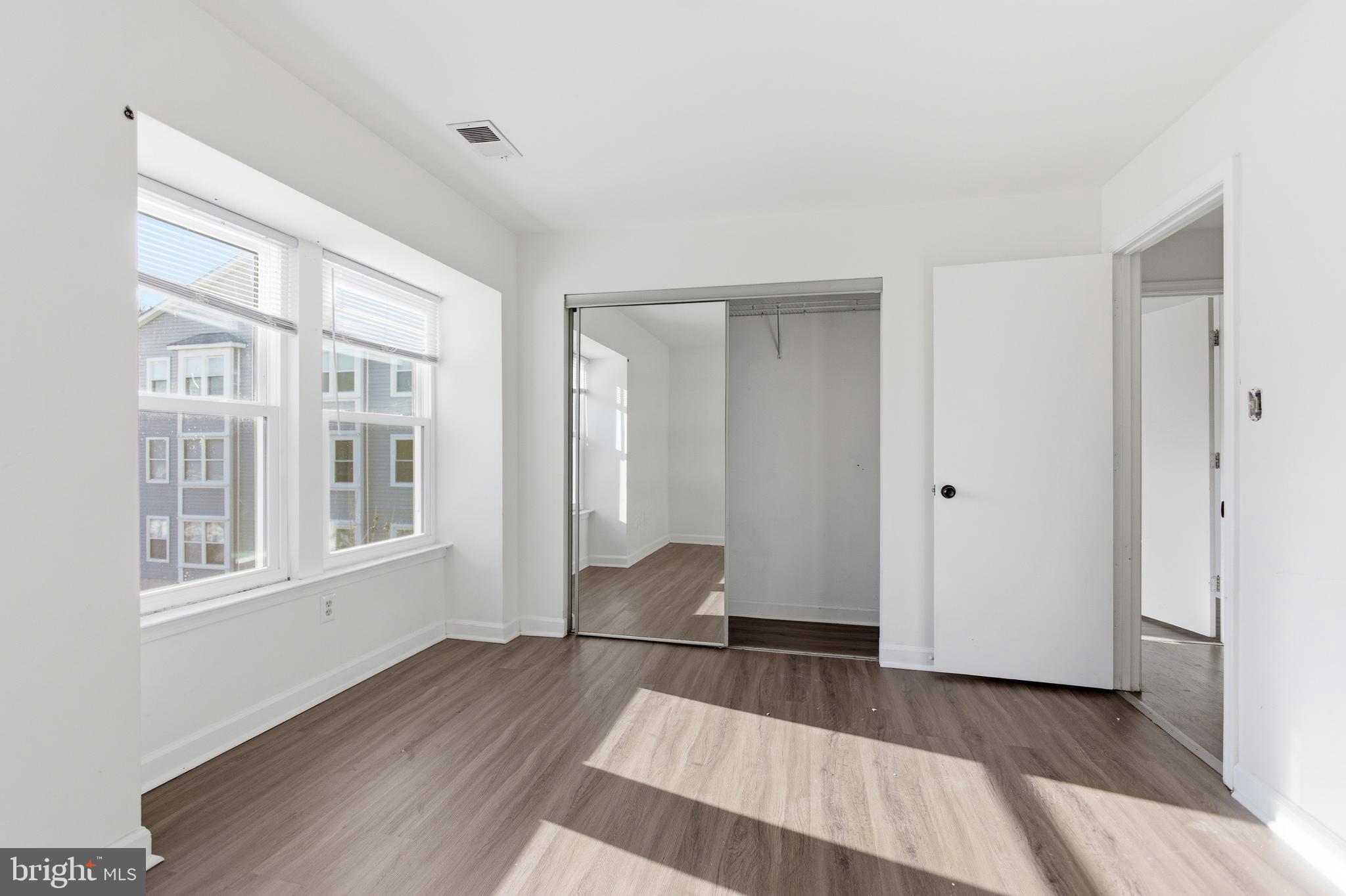 13609 Sir Thomas Way, Unit 1C24 Silver Spring, MD 20904 - Photo 8 of 16 a view of wooden floor and windows in a room