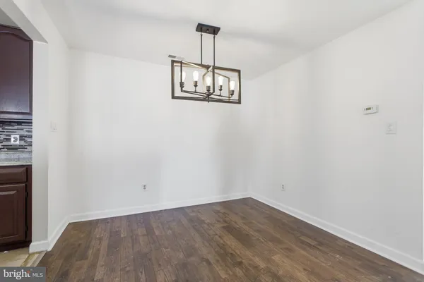 an empty room with a window and ceiling fan