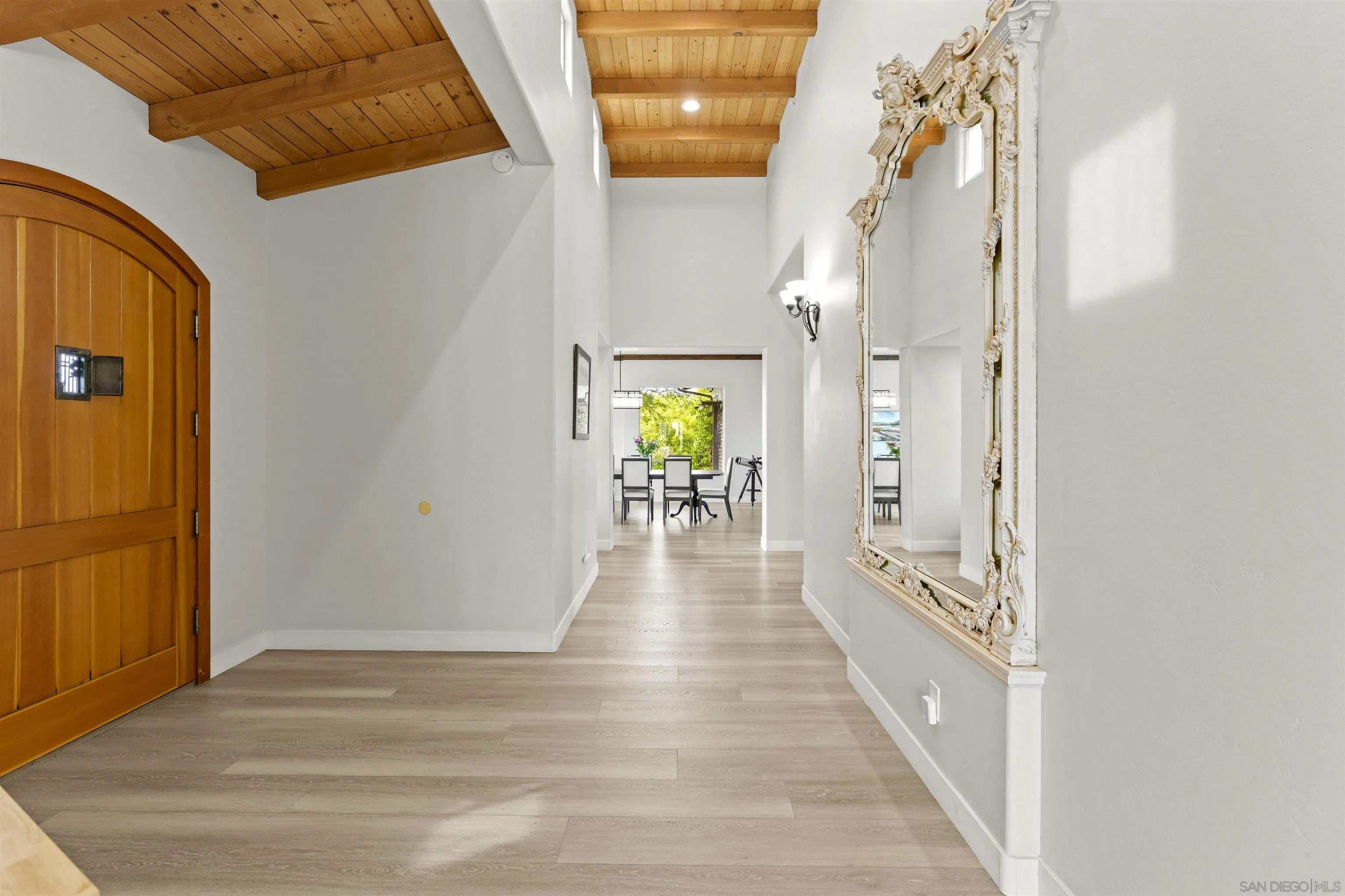 30659 Diaz Road Valley Center, CA 92082 - Photo 20 of 44 a view of a hallway with wooden floor and a dining room