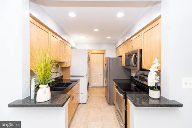 a kitchen with a refrigerator and a sink