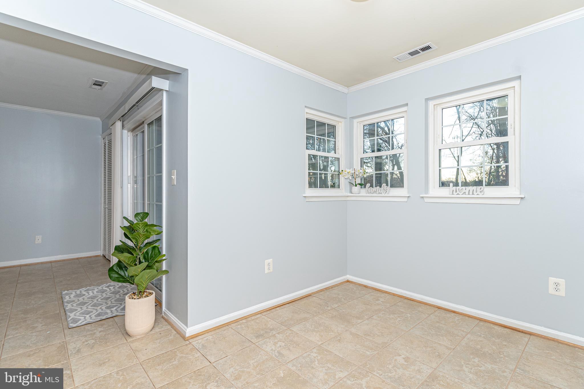 8347 Montgomery Run Road, Unit B Ellicott City, MD 21043 - Photo 15 of 39 a view of an empty room with potted plant and windows