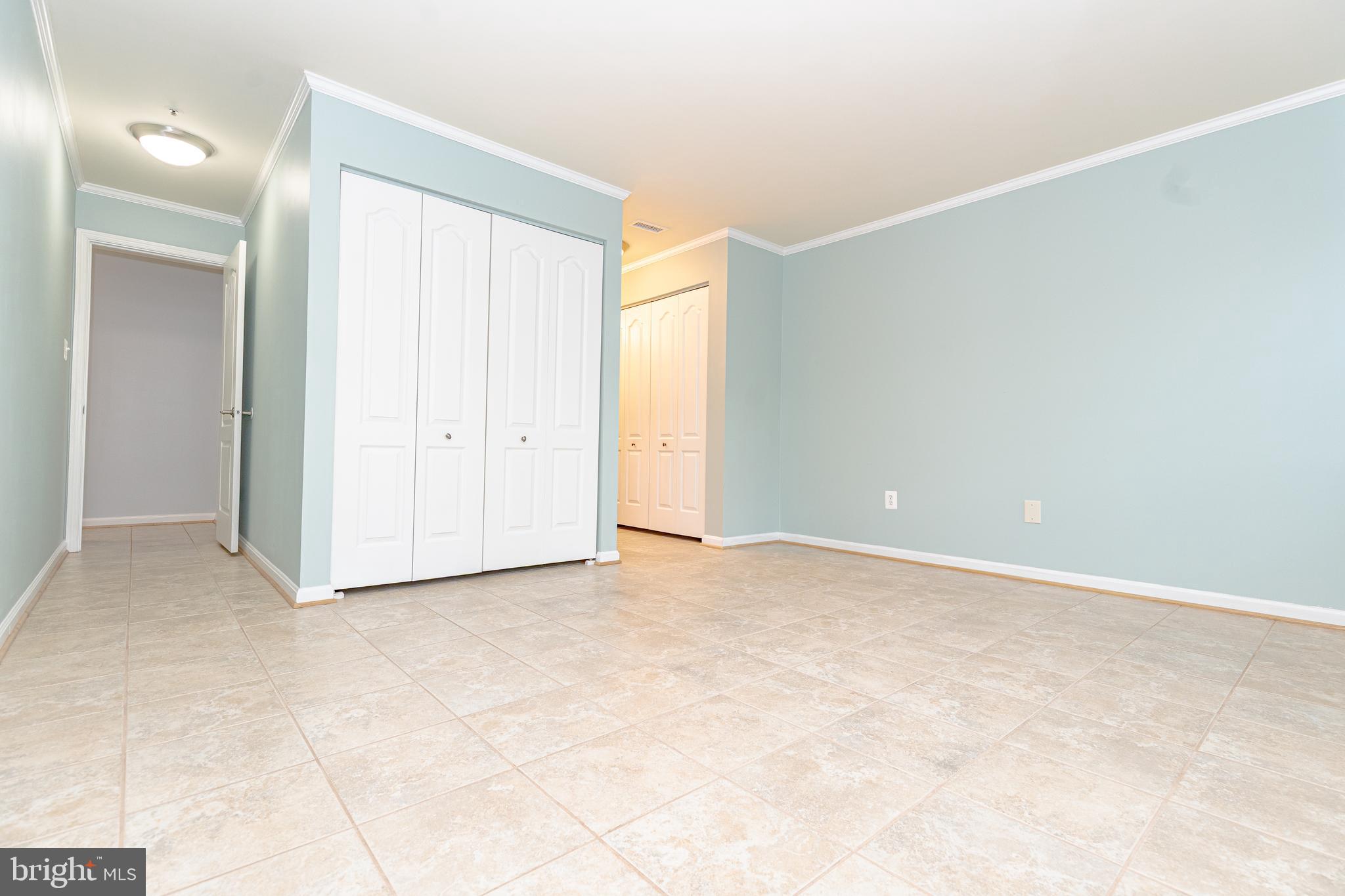 8347 Montgomery Run Road, Unit B Ellicott City, MD 21043 - Photo 19 of 39 an empty room with windows and entrance to other room