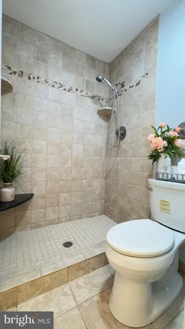 a bathroom with a toilet and shower