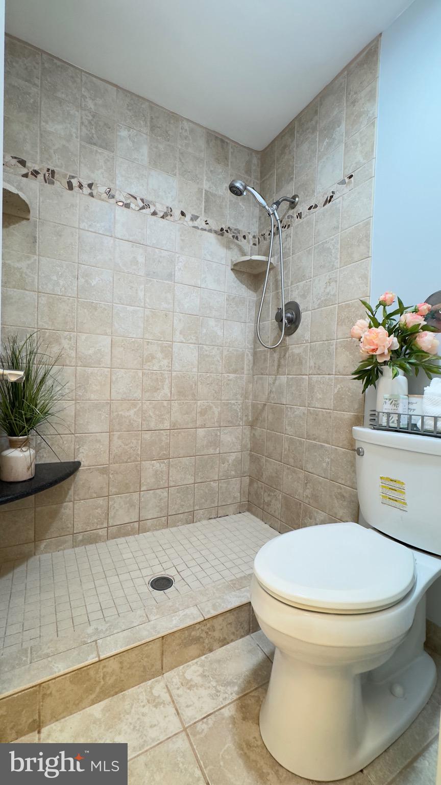 8347 Montgomery Run Road, Unit B Ellicott City, MD 21043 - Photo 22 of 39 a bathroom with a toilet and shower
