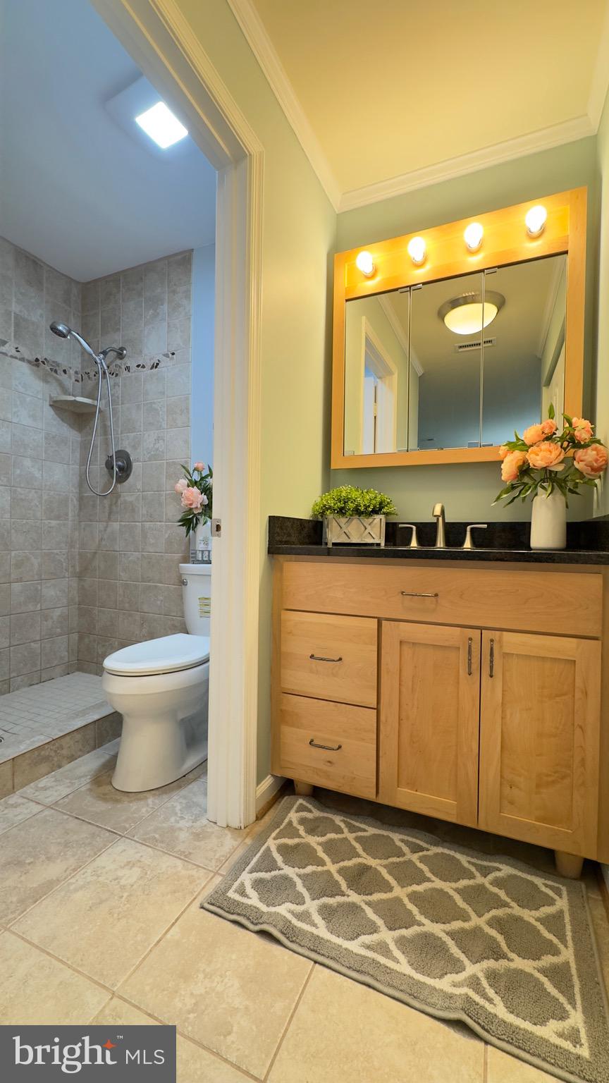 8347 Montgomery Run Road, Unit B Ellicott City, MD 21043 - Photo 23 of 39 a bathroom with a sink and a mirror