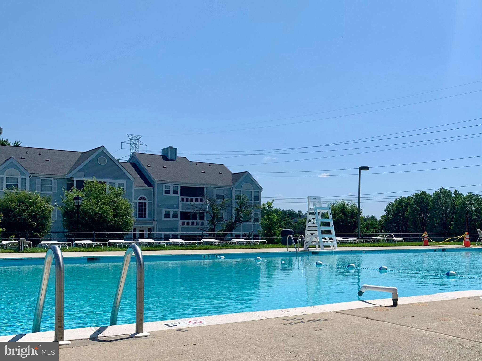 8347 Montgomery Run Road, Unit B Ellicott City, MD 21043 - Photo 35 of 39 a view of a house with a yard and a pond