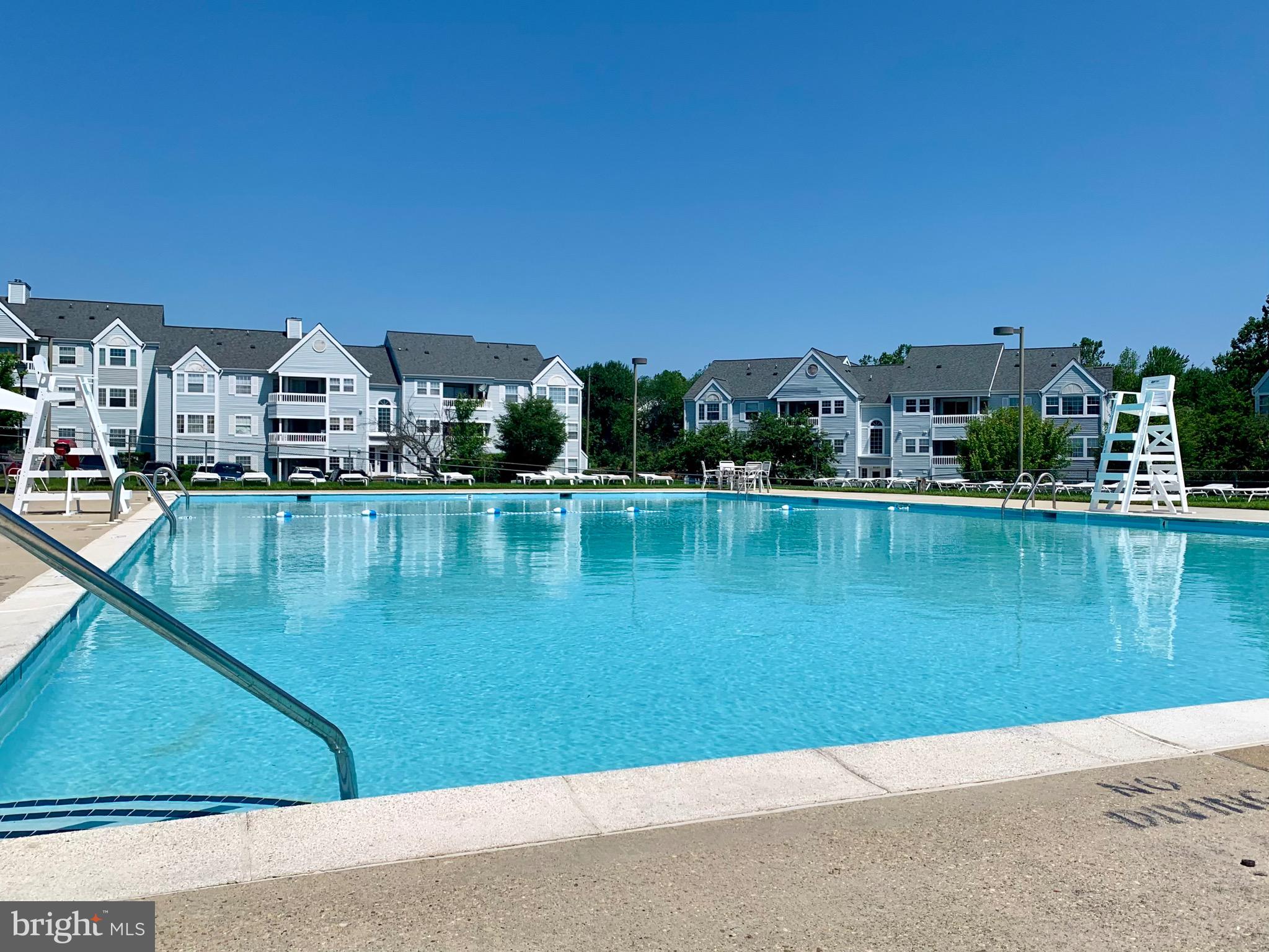 8347 Montgomery Run Road, Unit B Ellicott City, MD 21043 - Photo 37 of 39 a view of a lake with a houses in the background